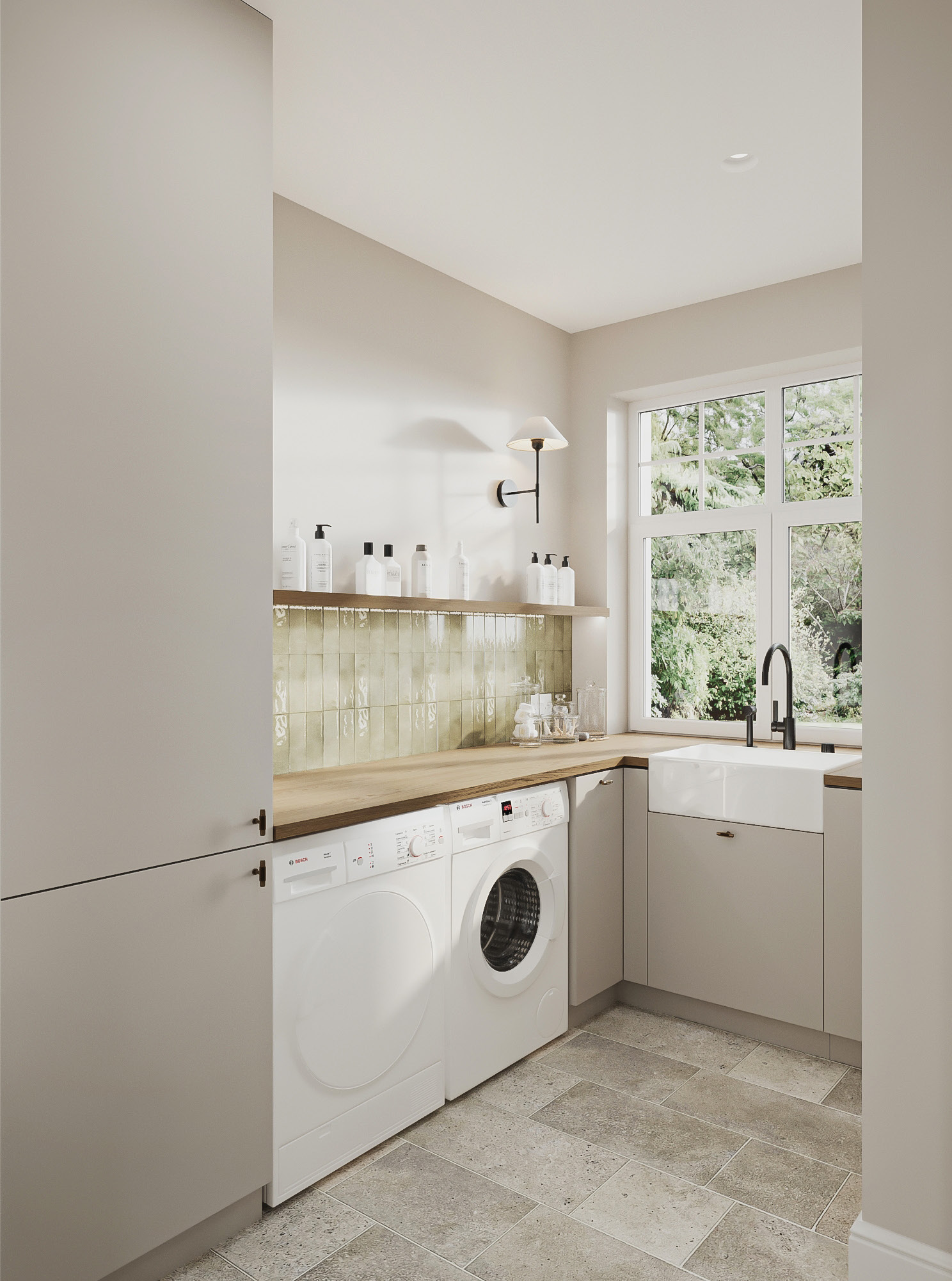 Utility room in soft grey shaker joinery, with a honed stone worktop, deep butler sink and antique brass fittings